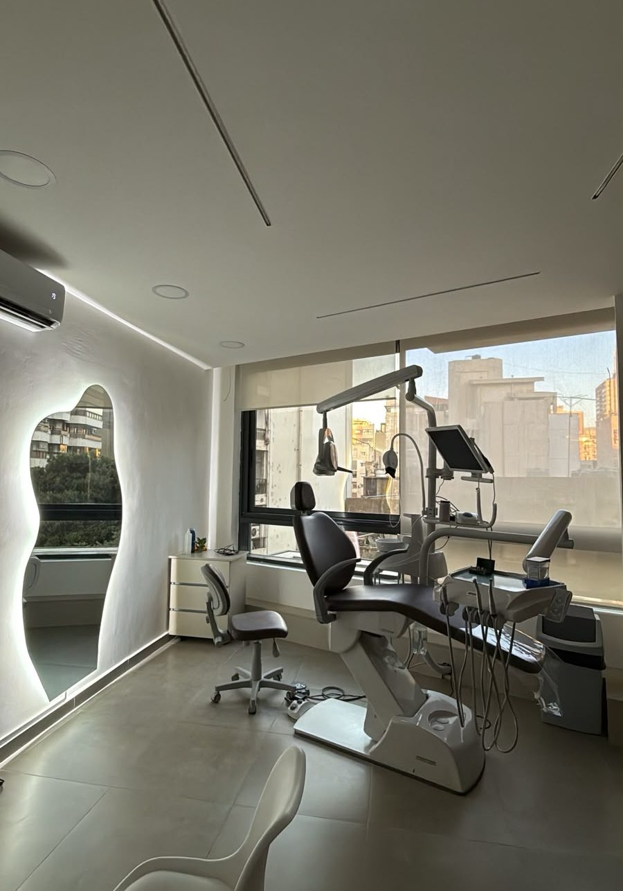 Treatment room with a backlit sculpted mirror and city window