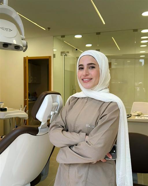 Dr. Fatima Nasser standing beside the dental chair in her clinic in Mar Elias, Beirut