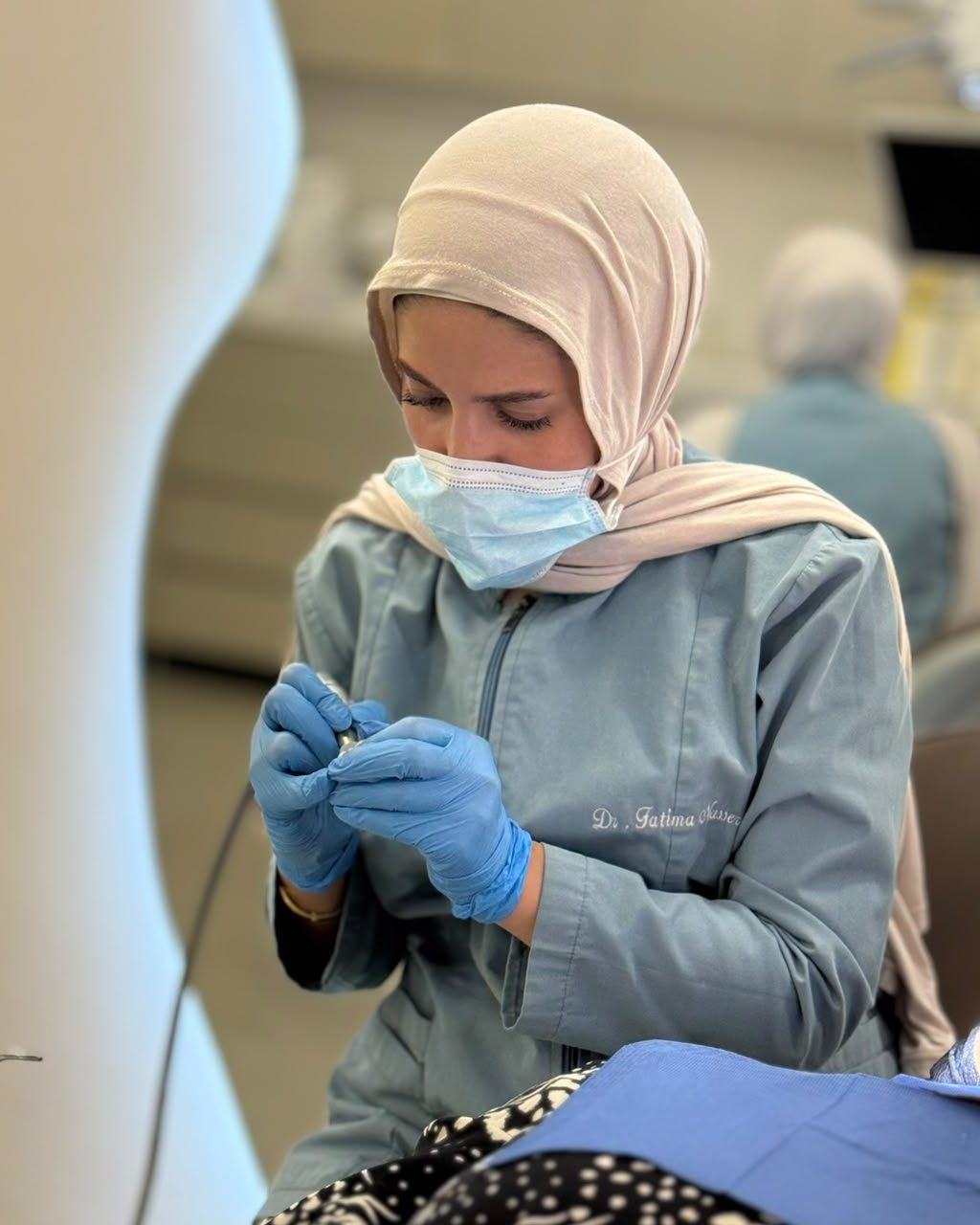 Dr. Fatima Nasser working under magnification